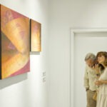 Wnętrze galerii. Mężczyzna i kobieta w okularach. Oglądają Dyptyk - dwu częściowy obraz