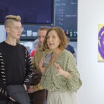 Wernisaż wystawy "Paint and Print?". Koordynatorka Magdalena Krowicka rozmawia z mężczyzną.